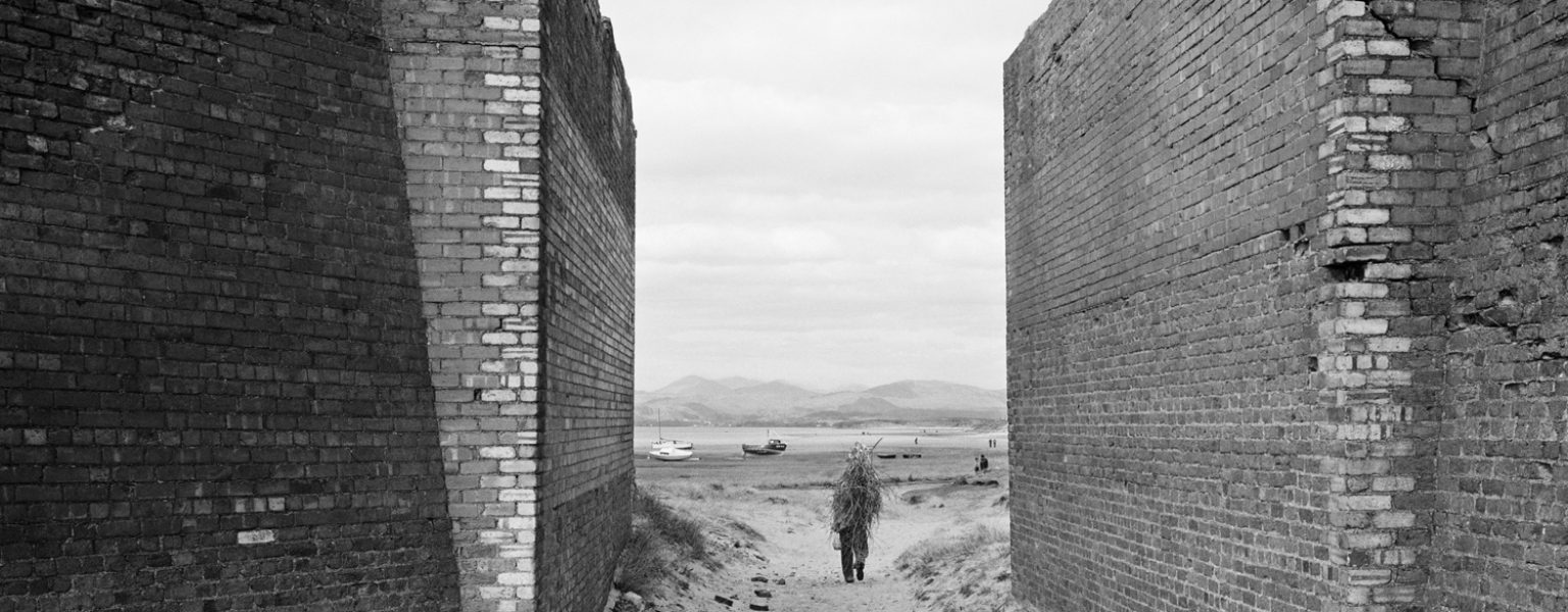 Man carrying sticks, Askam-in-Furness, Cumbria, 1982. © Chris Killip Photography Trust _ Magnum Photos, courtesy of Martin Parr Foundation
